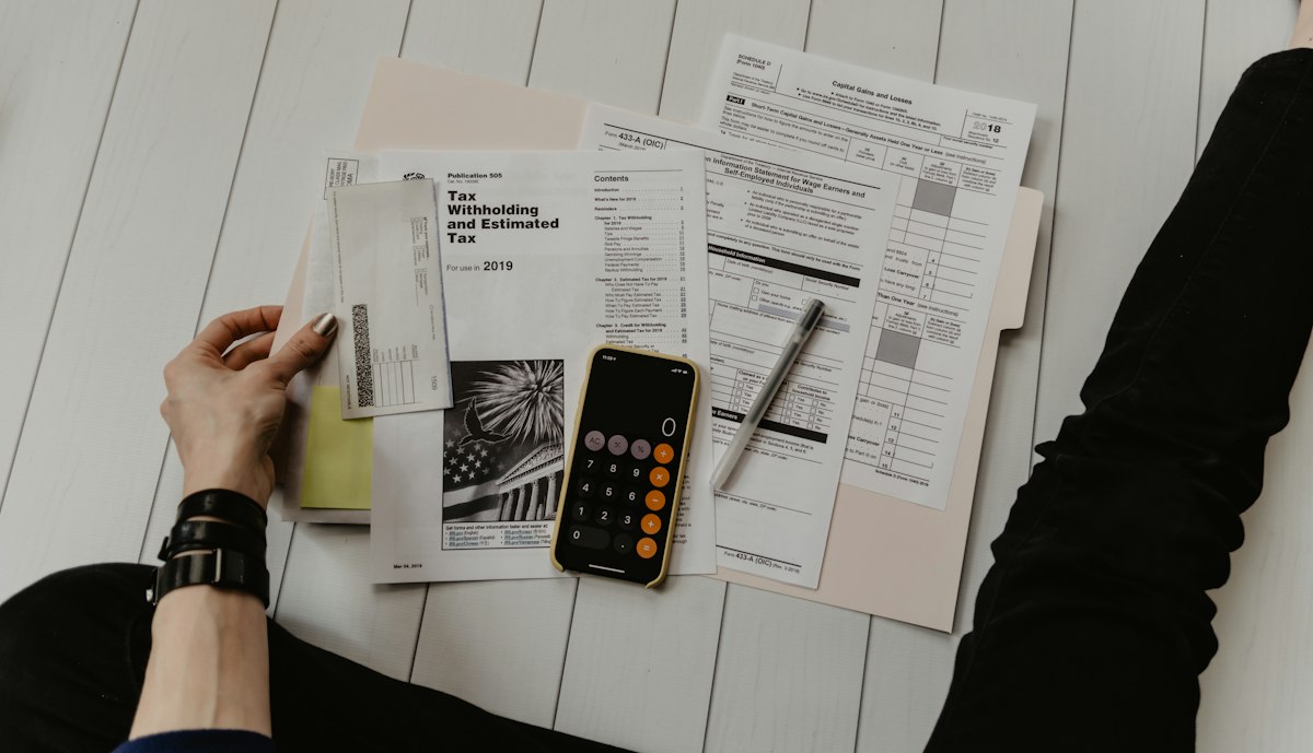 Calculator and policy documents on a desk